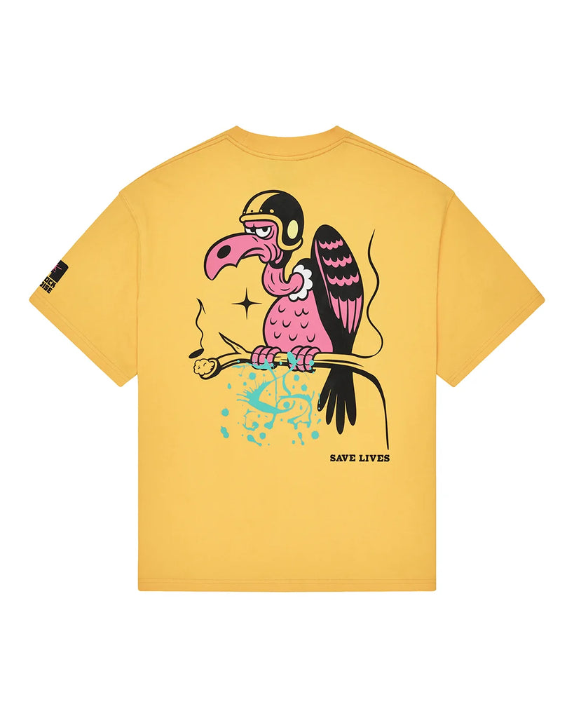 A yellow short-sleeve t-shirt with a colorful graphic of a cartoon dodo bird wearing a helmet and goggles, perched on a branch with blue paint splatters and the text 'SAVE LIVES' printed below it.