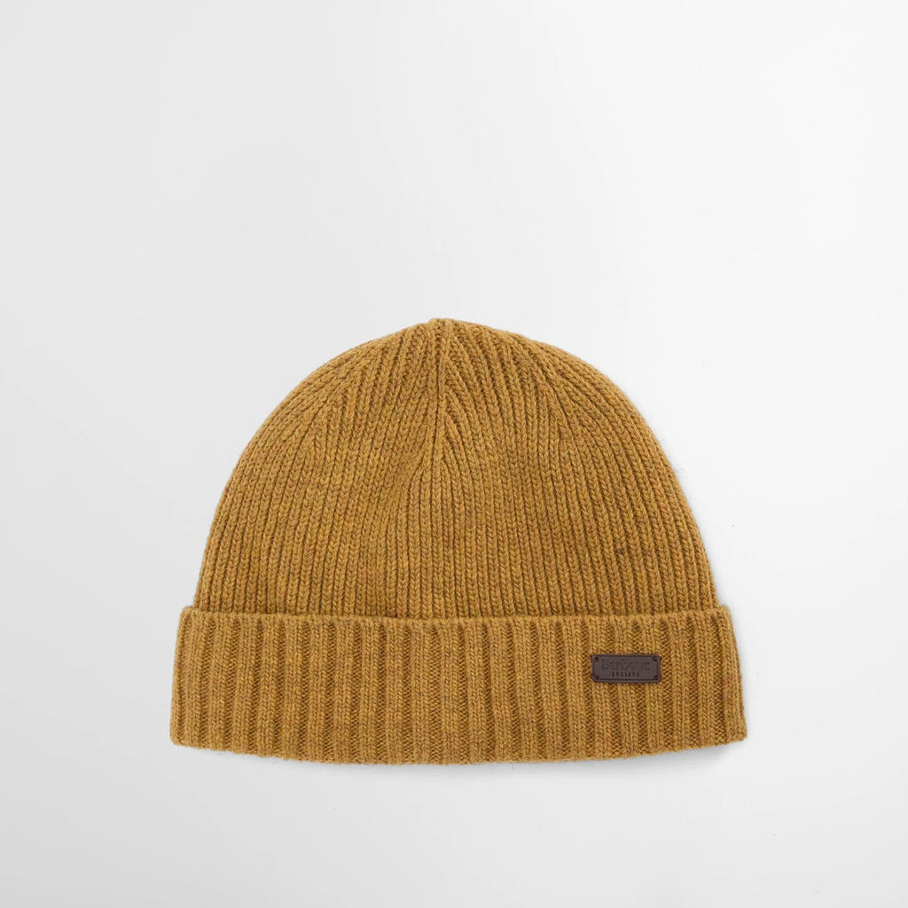 Mustard yellow beanie with a brand logo on a light gray background
