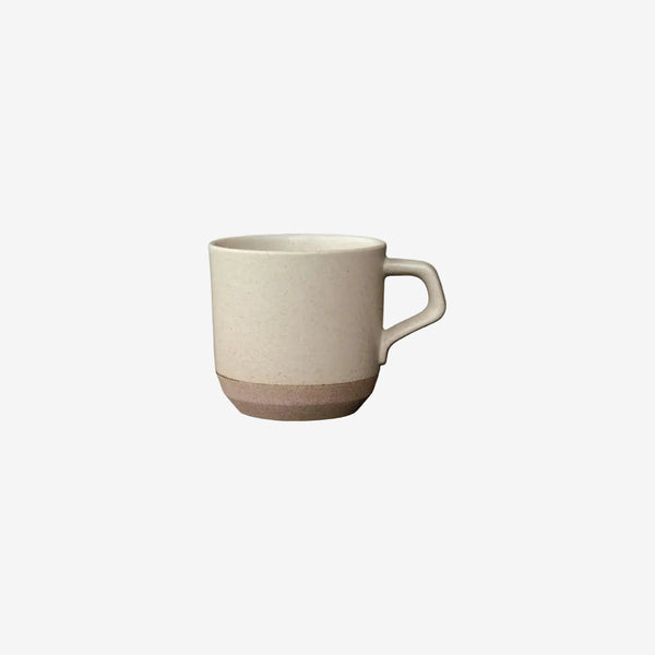 Beige ceramic mug on a white background