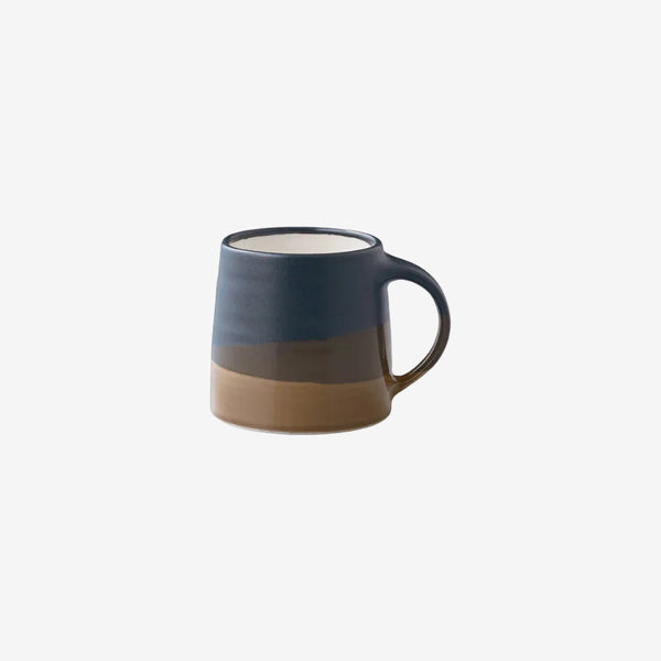 Two-tone ceramic mug with a dark blue top and brown bottom on a white background