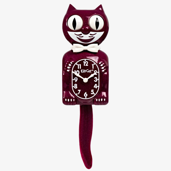 Cat-shaped clock with a red body and white face on a white background